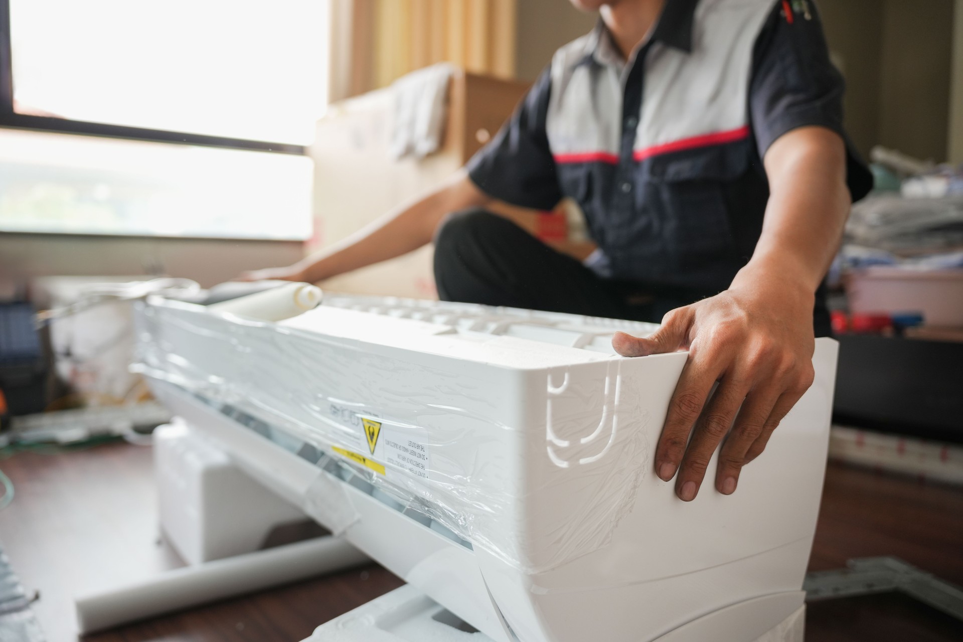 Air conditioning technician man  install new air conditioners in homes, Repairman fix air conditioning systems, Male technician service for repair and maintenance of air conditioners